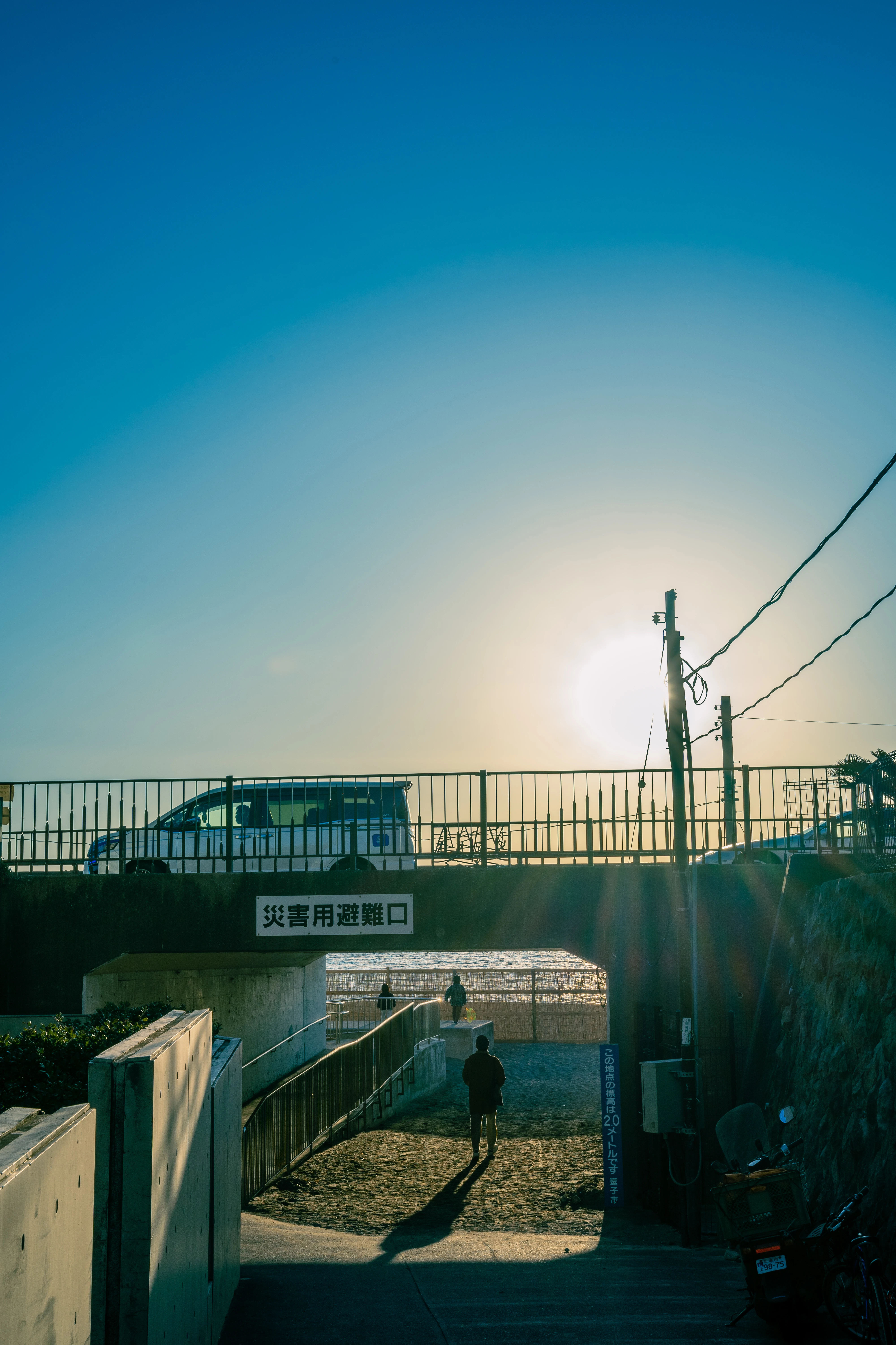 Silhouettes and Sunset Beyond the Coastal Underpass